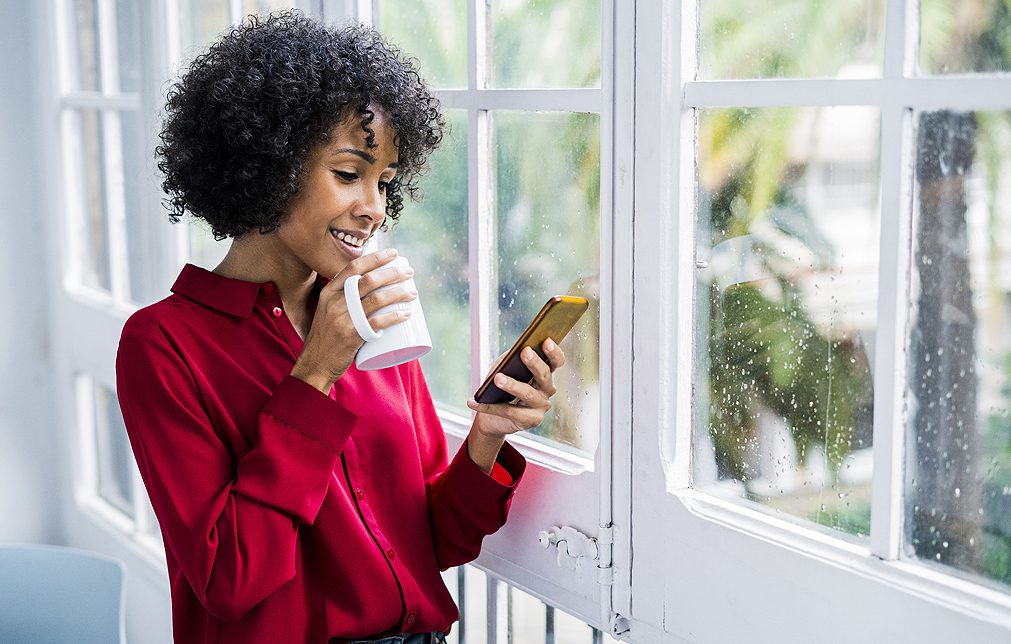 Adkins-Heating-and-Cooling-Heat-woman-drinking-coffee-near-window